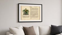 
Load image into Gallery viewer, Matching black frame with white mount shown holding a Last Name Origin print (Byrne sample) above a sofa